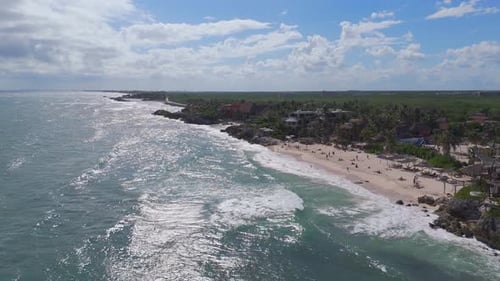 Gentle waves rolling into the white sand beach at Tulum, Quintana Roo Aerial view