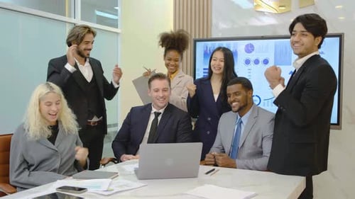 Diverse Team Celebrates Success in Modern Office