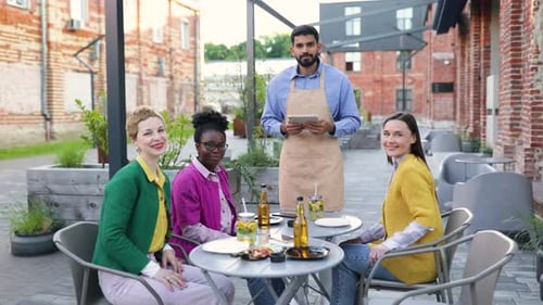 Stylish Friends Enjoying Lunch at a Brick Cafe
