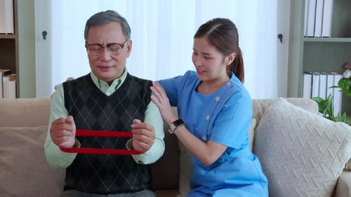Elderly Man Exercising with Physical Therapist at Home