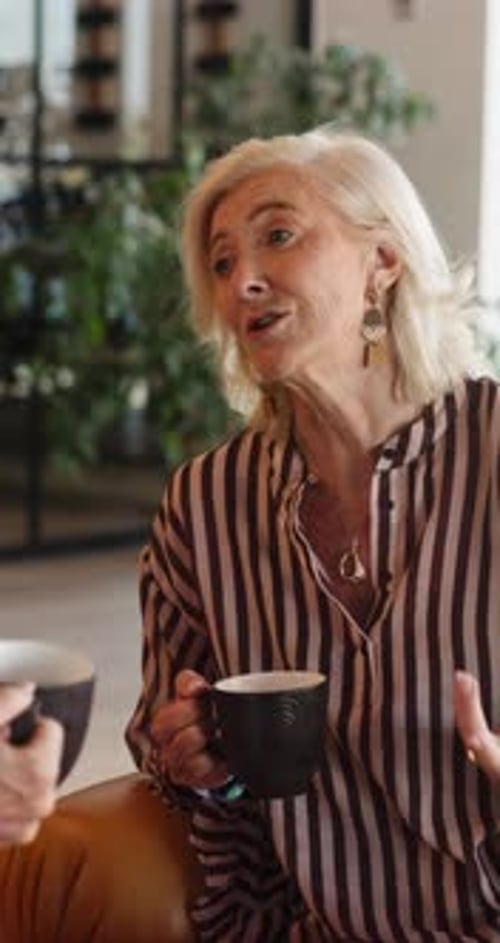 Senior Woman Talking and Holding Coffee Mug