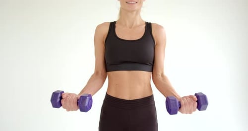 Fit Woman Doing Bicep Curls with Dumbbells