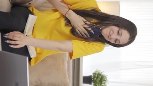 Vertical video of Female student chatting with her boyfriend on the phone.