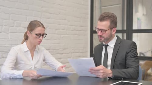 Business People Discussing Business Report in Office