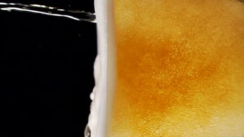 Close Up of Beer Pouring Into Glass