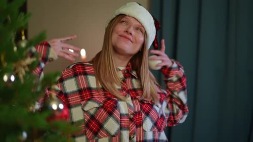 Festive Woman Dancing by Christmas Tree