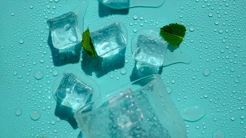 Ice Cubes and Mint on a Blue Background