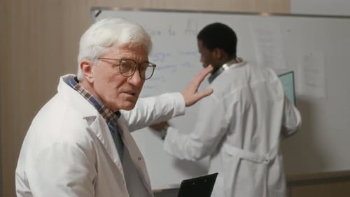 Doctors Reviewing Medical Information on Whiteboard