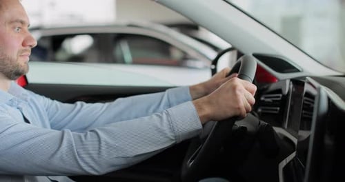 Young Man Auto Driver Car Owner Holding Steering Wheel Buy New Automobile Dealership Inside Vehicle