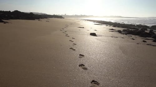 Footprints on the sand in the Atlantic coast.