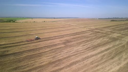 Tractor working on the field doing tillage with cultivator