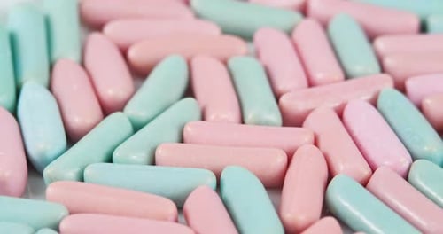Multicolor Chewing Candies Rotating Background. Sweets Concept. Unhealthy Food. Bright Blue and Pink