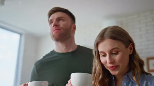 Young Adults Talking with Mugs Indoors