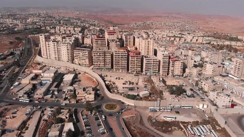 Aerial footage of Town Behind Concrete Wall with Army watch Tower
