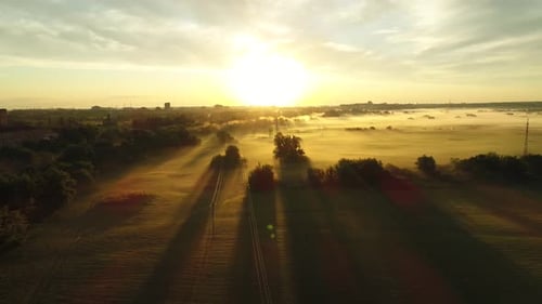 Aerial View of Foggy Fields at Sunrise