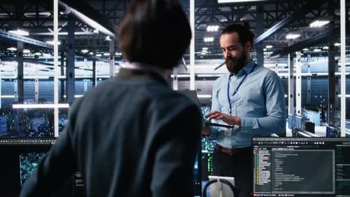 Data Center Technician Using Laptop to Monitor Neural Network AI LLM