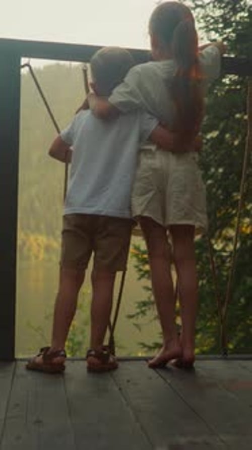 Boy and Girl Looking at Forest Landscape