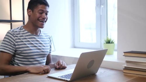 Adult Video Chatting Using Laptop at Home