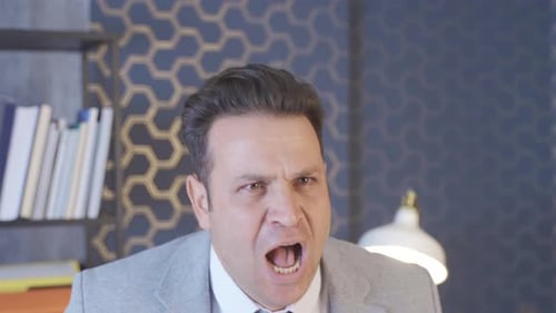Office worker having a nervous breakdown. Businessman yelling.