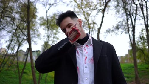 Man with Spooky Halloween Makeup and Painted Hand