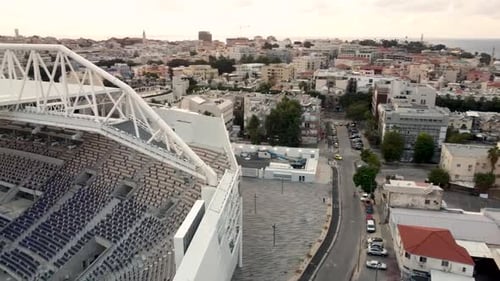Aerial turn shot of city old buildings reveal new football field empty, Israel Jaffa , drone shot.