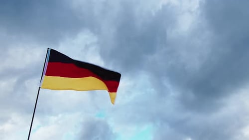 German Flag Waving Against Cloudy Sky