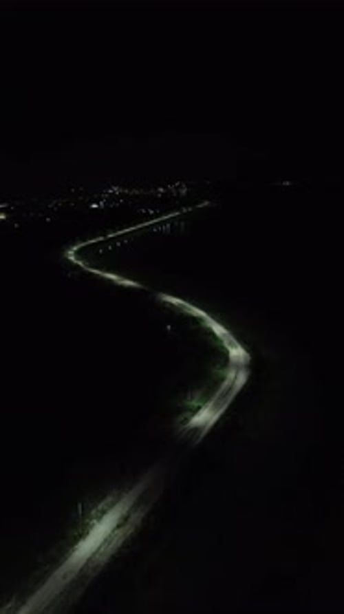Vertical drone footage of deserted street at night