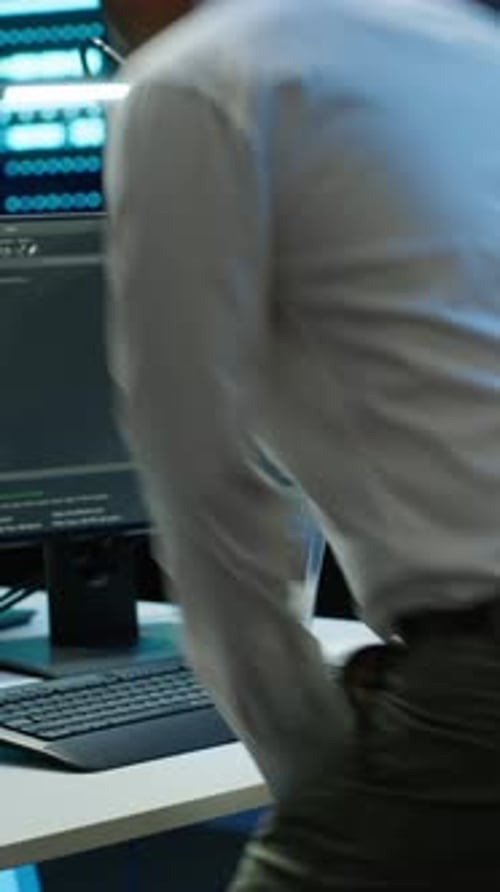 Man Coding on Computer in Modern Office