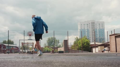 City Soccer Training Athlete Practicing Alone Outdoors Solo Player Dribbling on Rainy Street Urban
