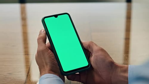 Man Holding Smartphone with Chroma Key Screen
