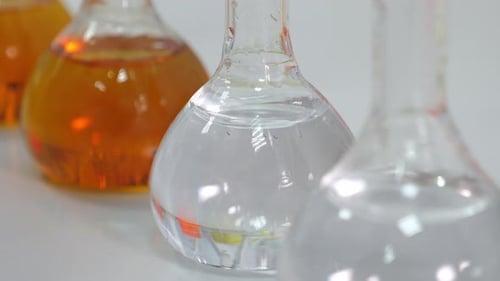 Close Up shot of lab ware and orange liquid