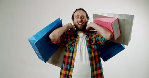 Excited Man With Shopping Bags Celebrates Big Sales