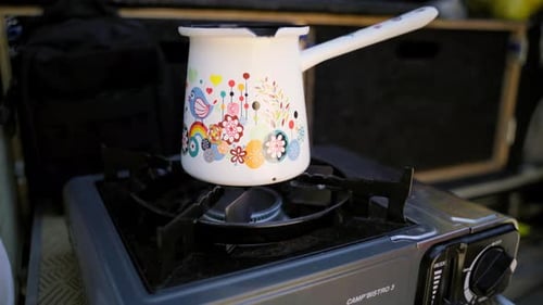 Blue flame gas cooker burner, with a coffee pot preparing the morning coffee.
