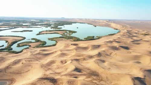 Desert Oasis with Sand Dunes and Lakes – 4K Drone Footage