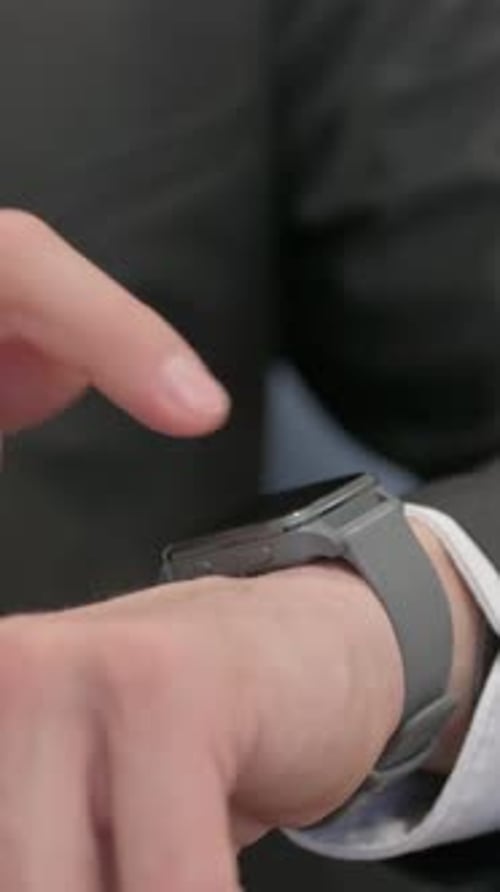 Close up of Middle Aged Businessman using Smart Watch, vertical video
