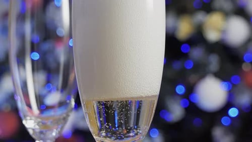 Champagne is Pouring Into a Glass Closeup View