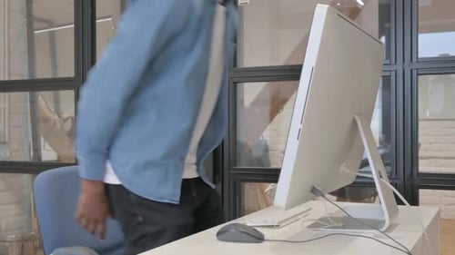 African Man Coming and Working on Computer