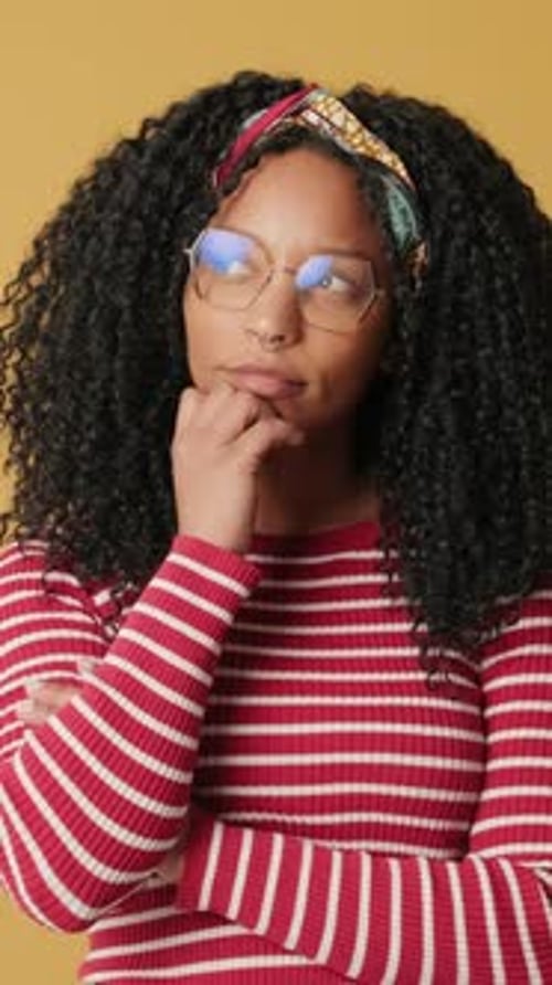 Woman Ponders, Hand to Chin in Studio