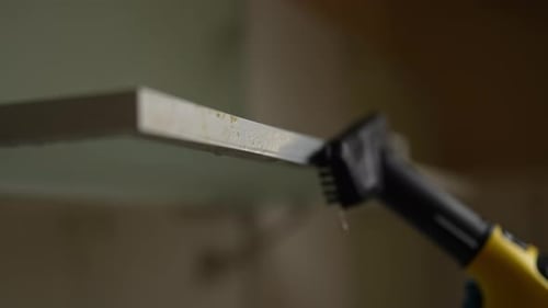 Hand Held Steam Cleaner Cleaning White Surface