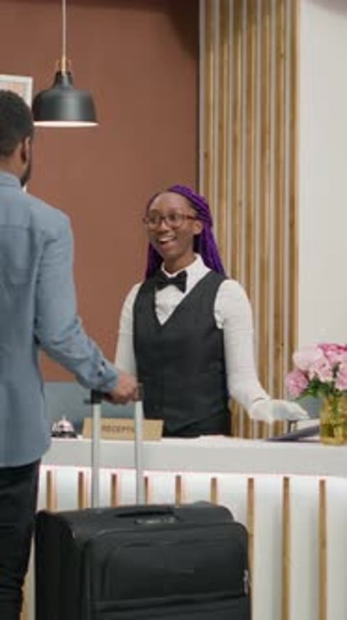 Man Arrives at Modern Hotel Reception Desk