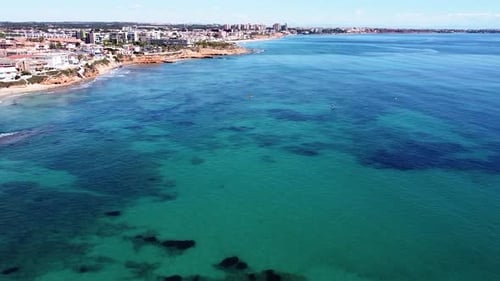 Aerial drone view of cityscape and coastline of Mil Palmeras beach and Pilar de la Horadada in Spain