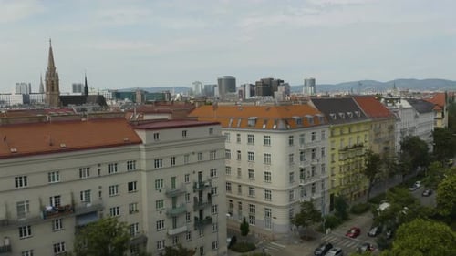 Aerial drone forwarding shot over residential buildings through the old town of Vienna, Austria. Bea