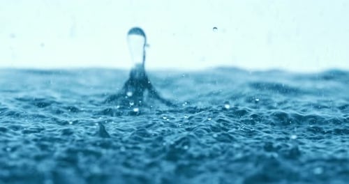 Rain water drops falling in super slow motion.