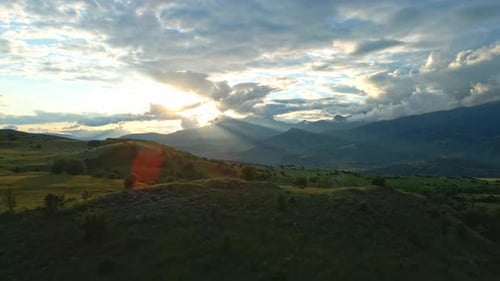 Aerial view mountain range with a sun shining on it
