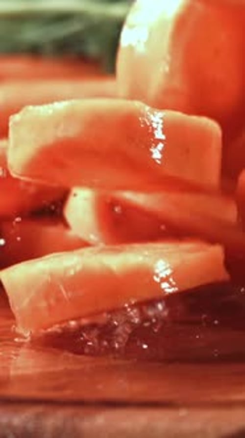 Pieces of Chopped Carrots Fall Onto a Wet Board Filmed on a Highspeed Camera at 1000 Fps