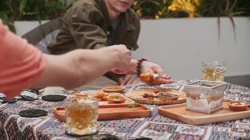 Man Giving Snack to His Friend while Hanging Out Together