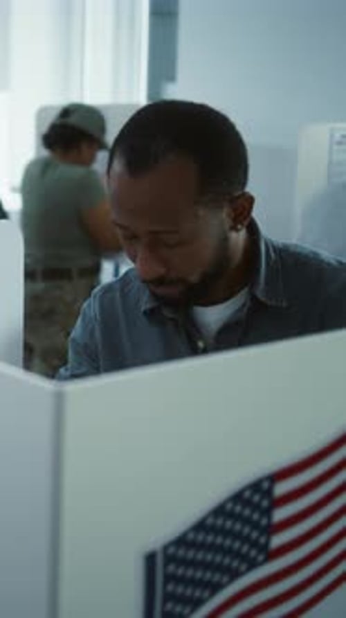 African American Man Comes to Vote in Booth in Polling Station