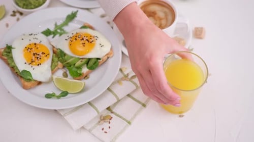Toast with Avocado and Eggs with Latte and Juice