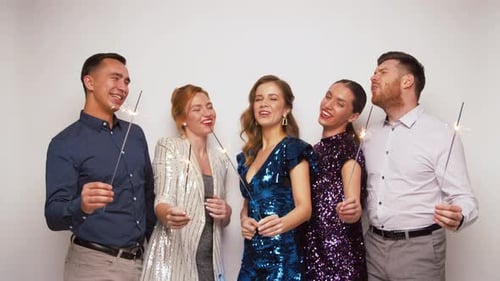 Group of friends celebrate with sparklers and laughter