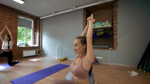 Yoga Class Led by Instructor in Bright Studio